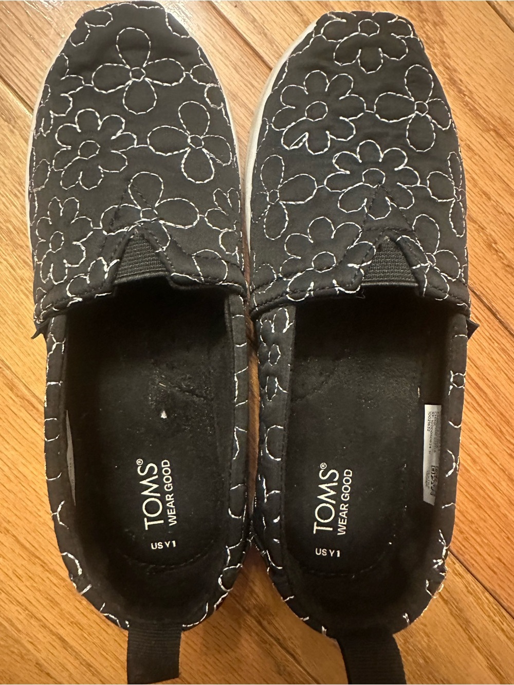 TOMS Black Slip-On Shoes with White Floral Stitching